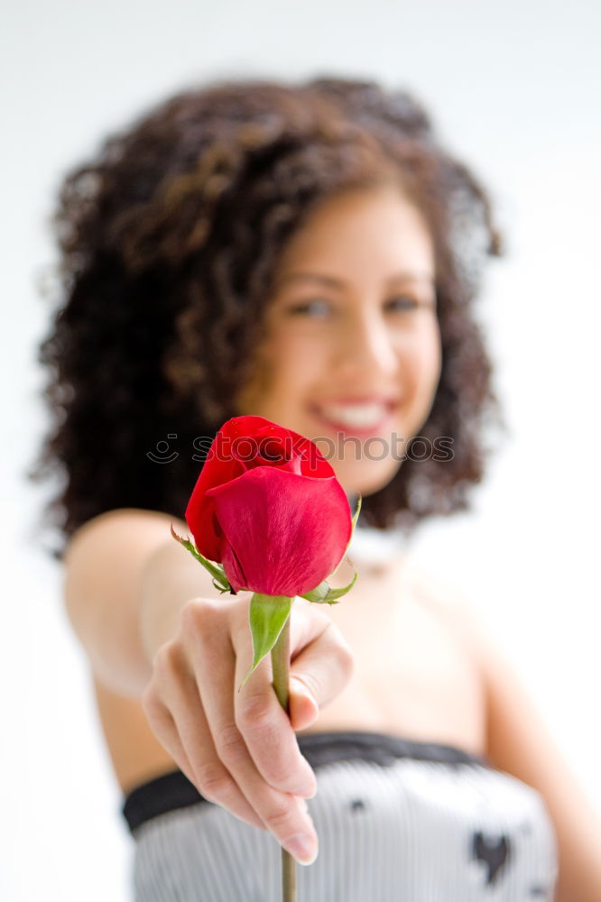 Similar – Redhead woman smelling a flower in a park