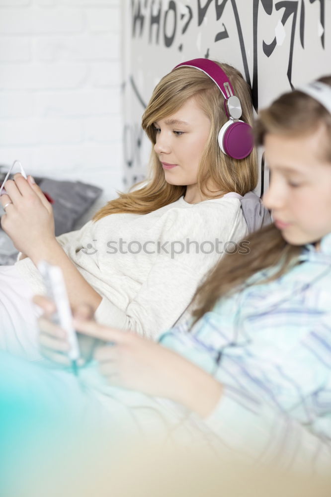 Similar – Image, Stock Photo Top shot of brother and sister listening to music together from smartphones