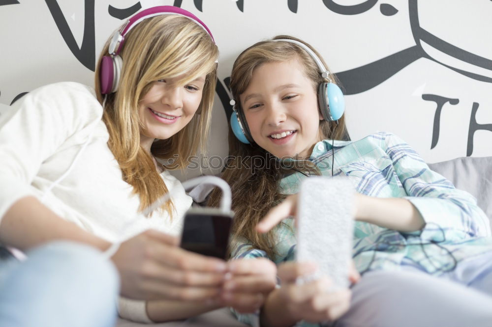 Image, Stock Photo Top shot of brother and sister listening to music together from smartphones