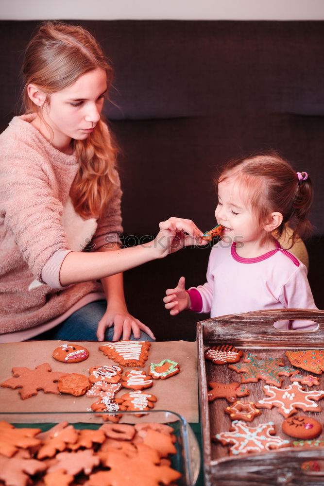 Similar – Family decorating baked Christmas gingerbread cookies with frosting