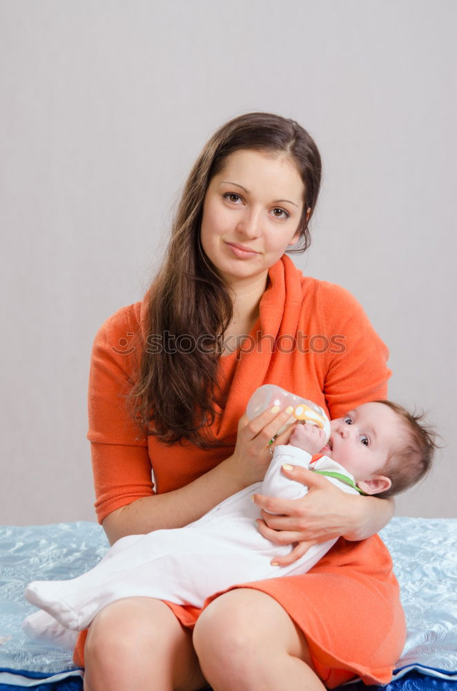 Similar – Image, Stock Photo Happy new mother is holding newborn baby in arms.