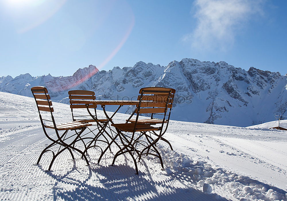 Similar – Sun loungers in the snow in front of mountain panorama