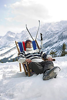 Similar – Sun loungers in the snow in front of mountain panorama