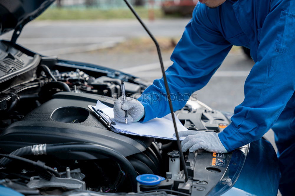 Similar – Professional Mechanic Repairing Car.