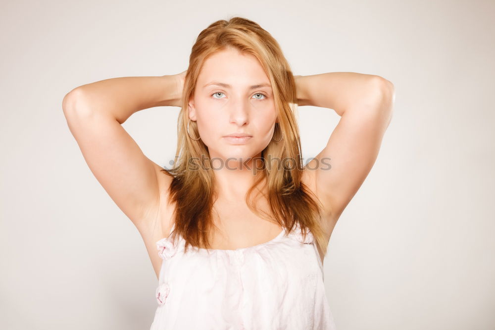 Similar – Young smiling blond woman leaning against wall