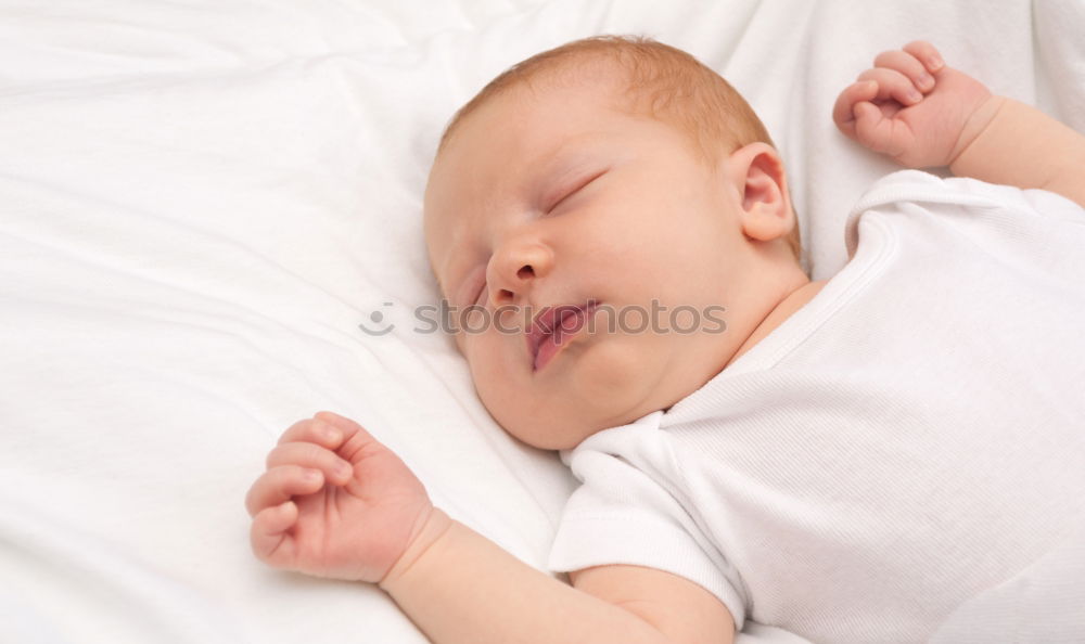 The back of a baby’s head lying on its stomach