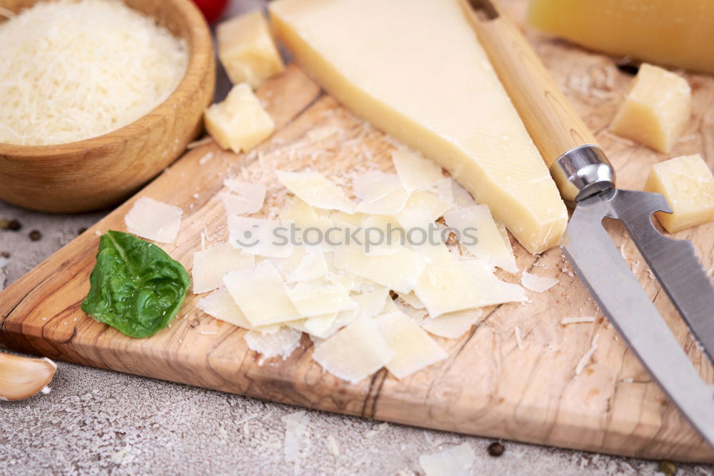 Similar – Image, Stock Photo parmesan cheese on plate of wood