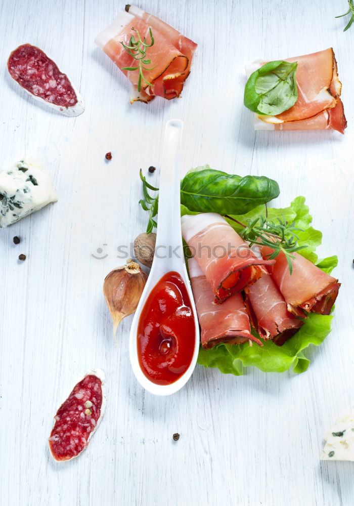 Parma ham with toast , basil pesto and tomatoes