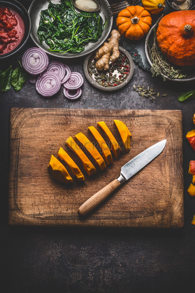 Sliced pumpkin on the kitchen table with cooking ingredients