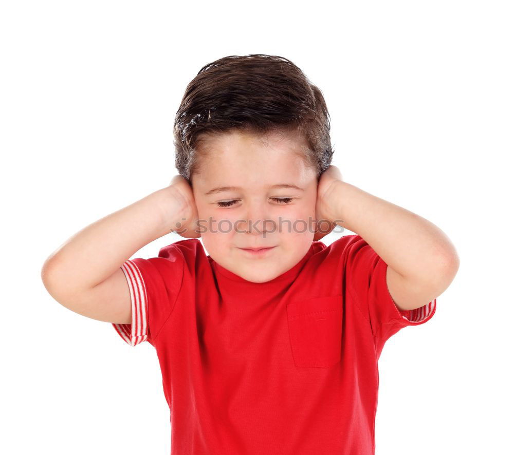 portrait of a Screaming little boy covering ears with hands