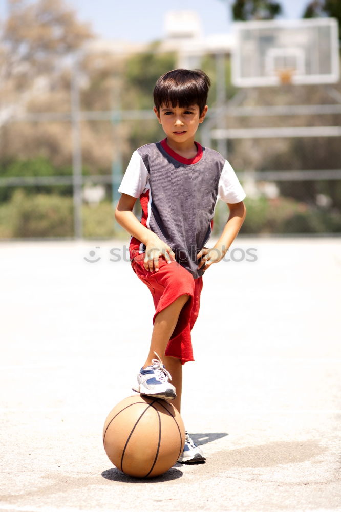 Similar – Teenage playing basketball on an outdoors court