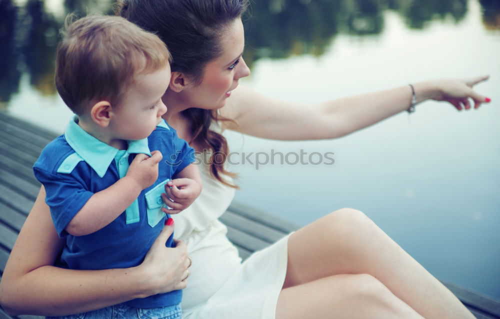 Similar – Sad mother and daughter sitting on bench in the park at the day time.