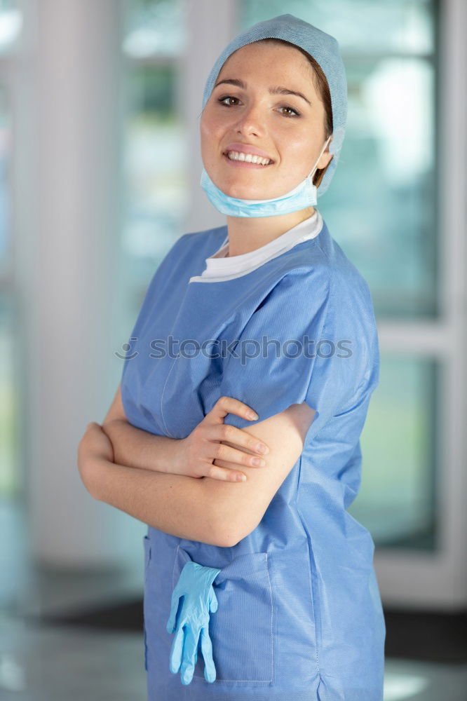 Similar – Smiling Female Doctor With Face Mask Wearing Scrubs In Busy Hospital During Health Pandemic