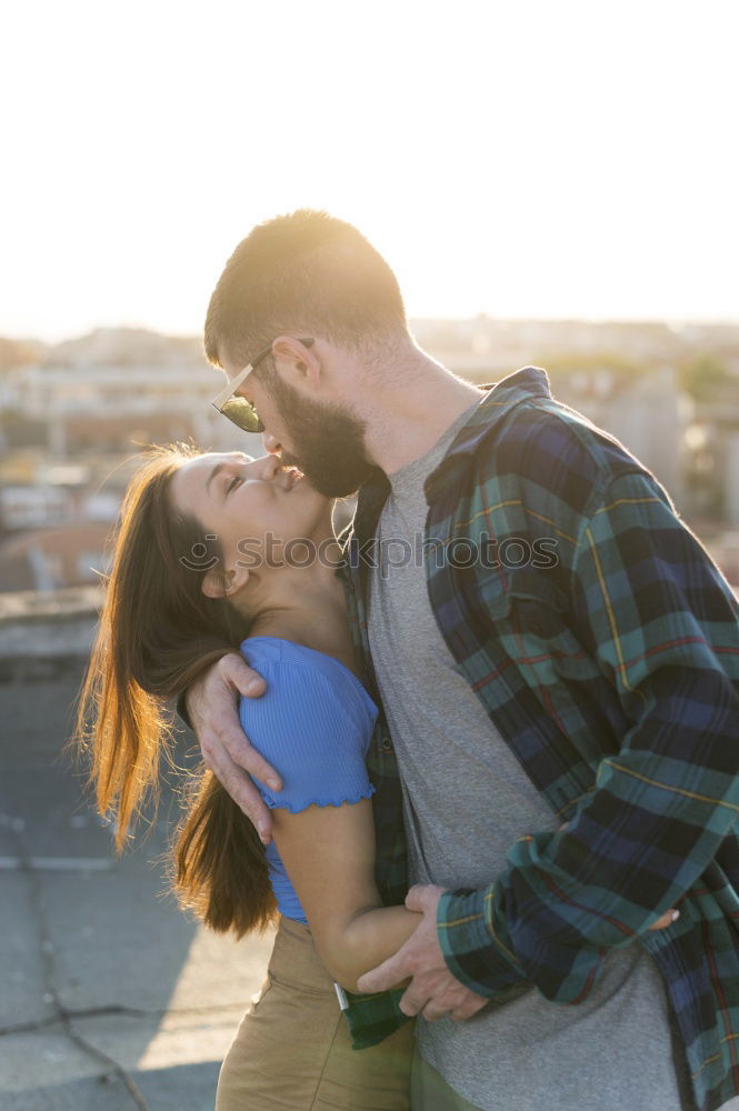 Similar – Portrait of beautiful couple in casual wear hugging in the street