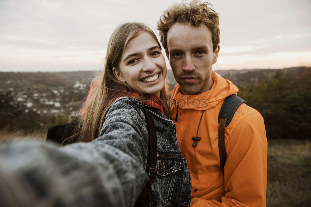 Similar – Image, Stock Photo Couple taking selfie photo in smartphone with sea and dark cloudy sky on background