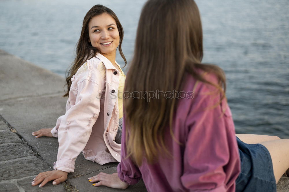 Similar – Two young women talking and laughing on urban steps