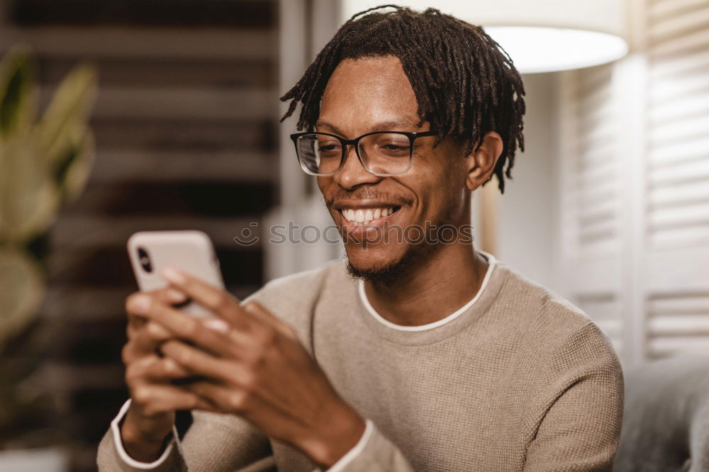 Image, Stock Photo Young black man using smart phone outdoors