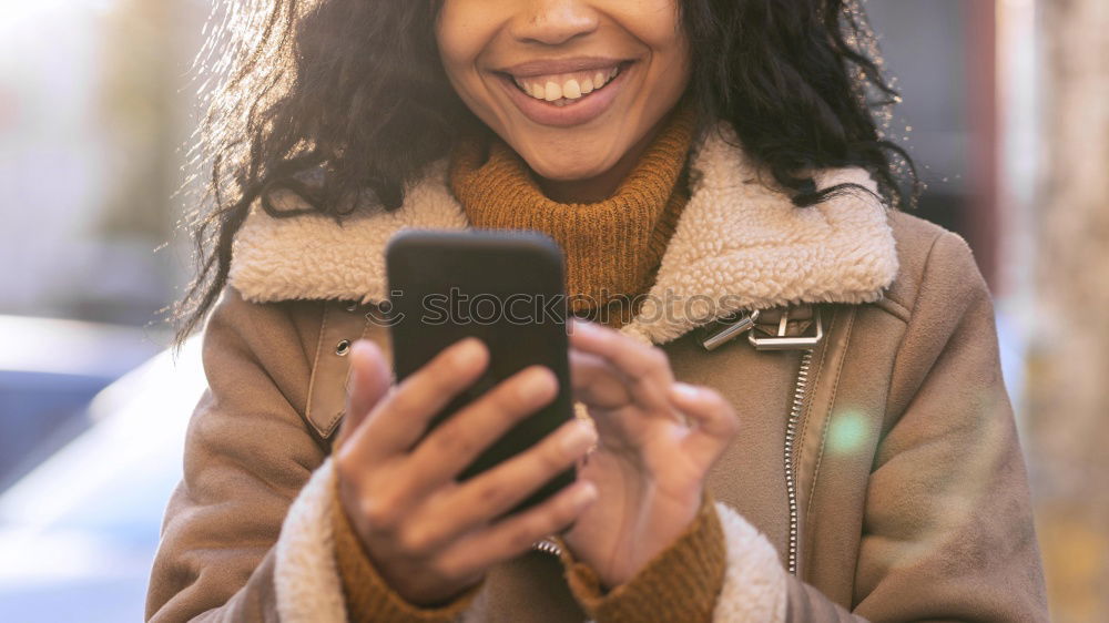 Similar – Happy woman with hat in city street, while using technology