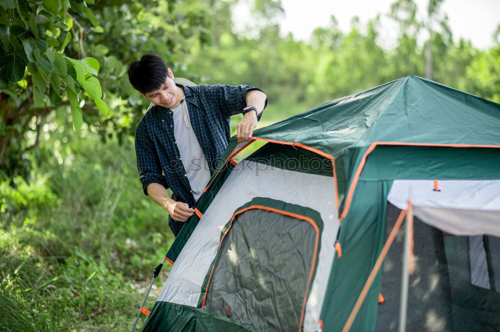 Similar – Couple planning next trip while sitting with map in tent. People relaxing in tent at camping during summer vacation