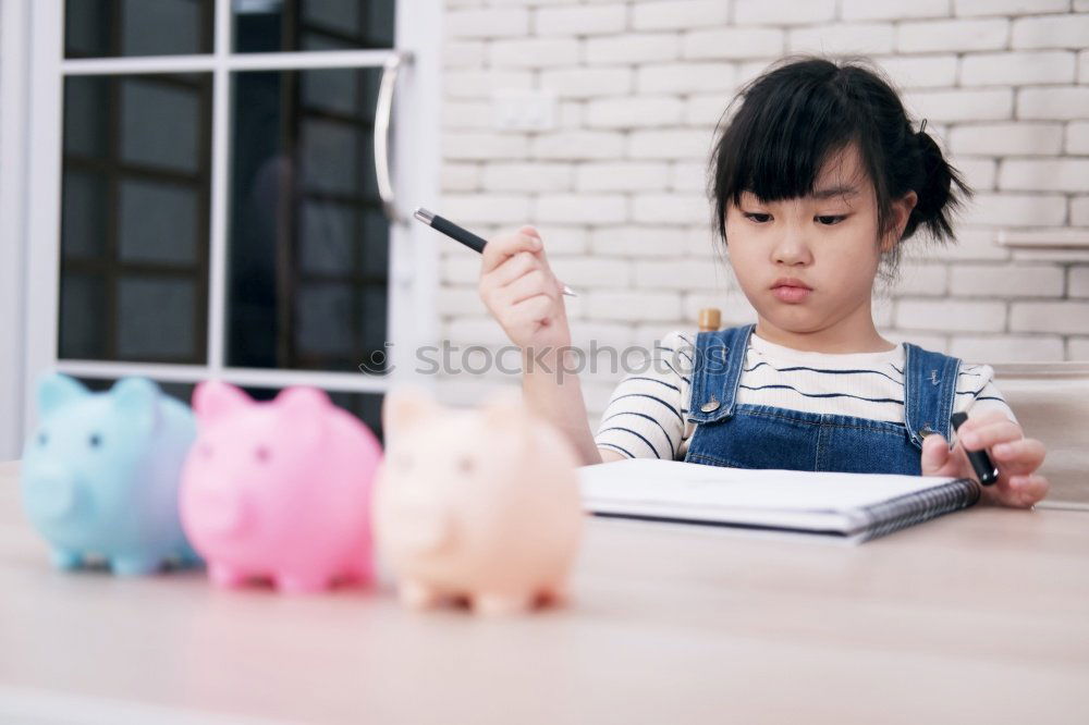 Similar – Thoughtful confused black woman with piggy bank