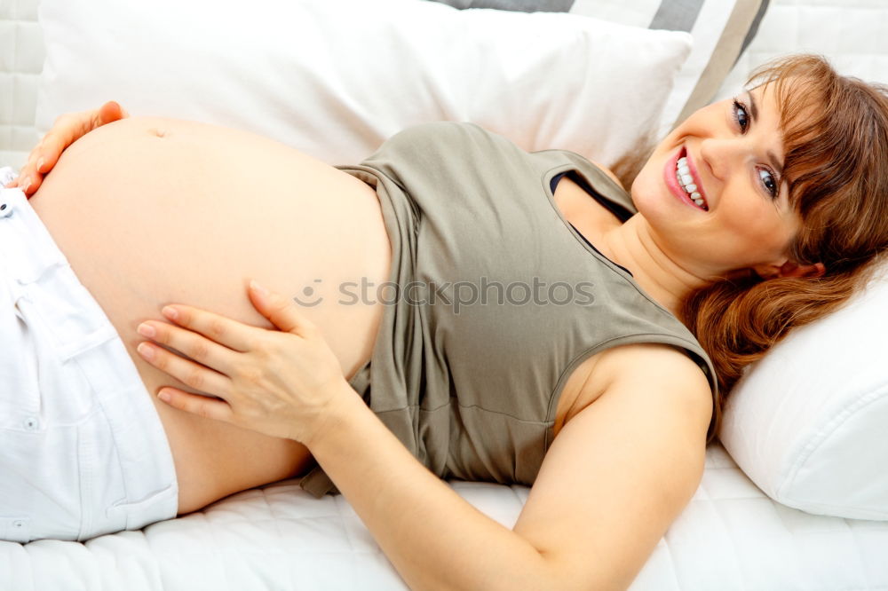 Similar – Pregnant woman touching her belly