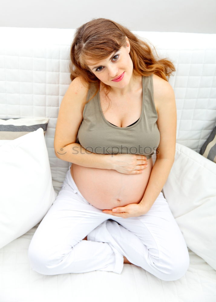 Similar – Pregnant woman touching her belly