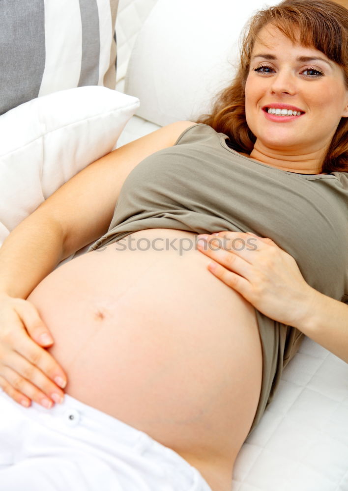 Similar – Pregnant woman touching her belly