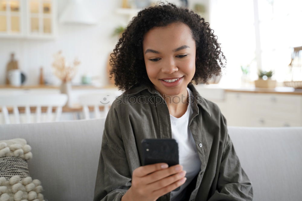 Similar – smiling young woman typing a message on cellphone