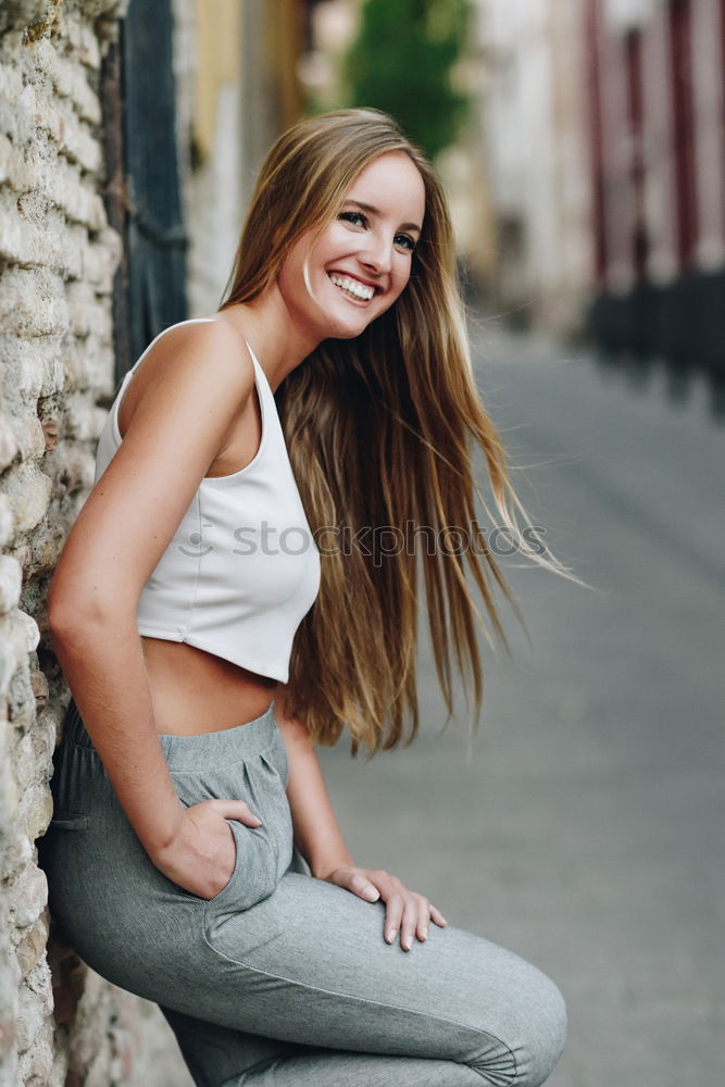 Similar – Young woman smiling in urban background.