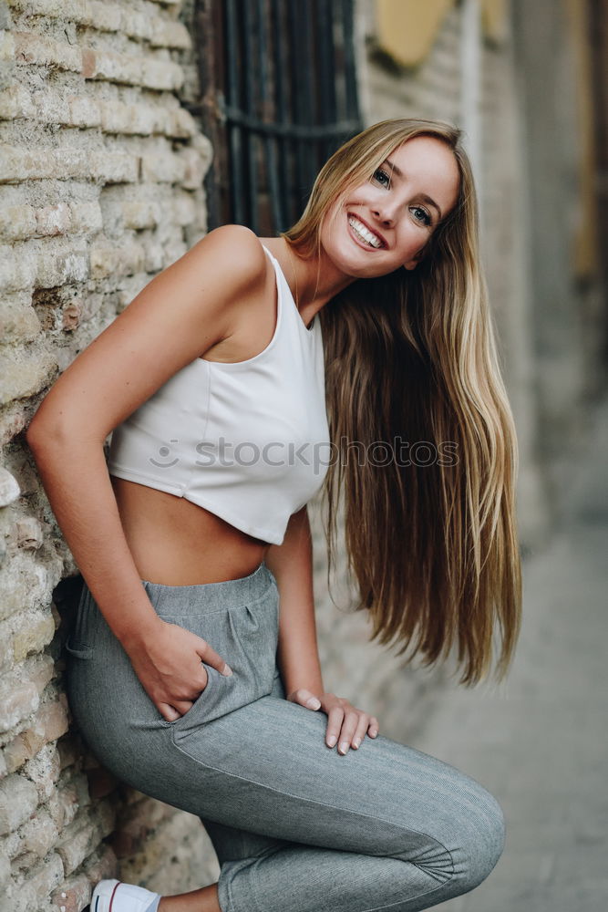 Similar – Young woman smiling in urban background.