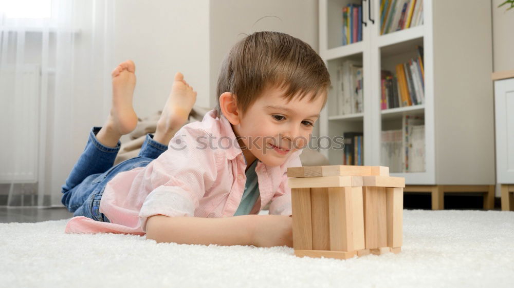 Similar – Toddler boy playing with new toy wearing pyjamas