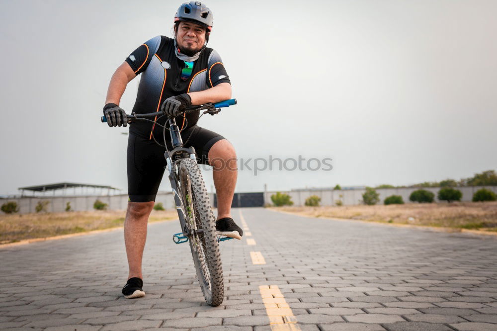 Similar – Image, Stock Photo Sporty young woman in helmet with bicycle looking at camera