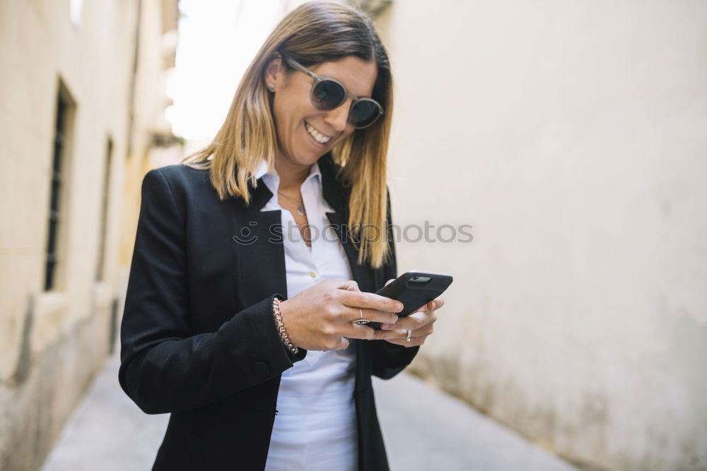 beautiful young woman using mobile phone and smiling