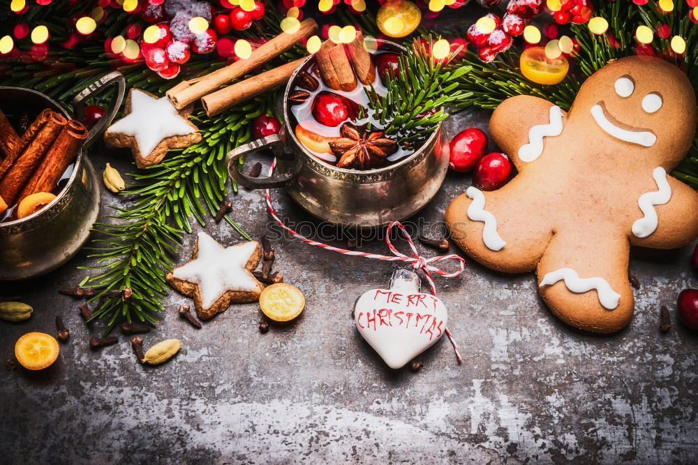 Gingerbread man with mulled wine, Christmas decoration and cookies