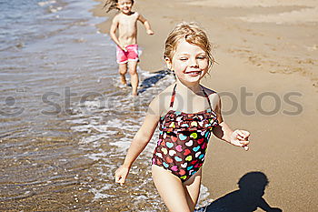 Similar – Two sisters and brother playing on the beach at the day time. Concept Brother And Sister Together Forever