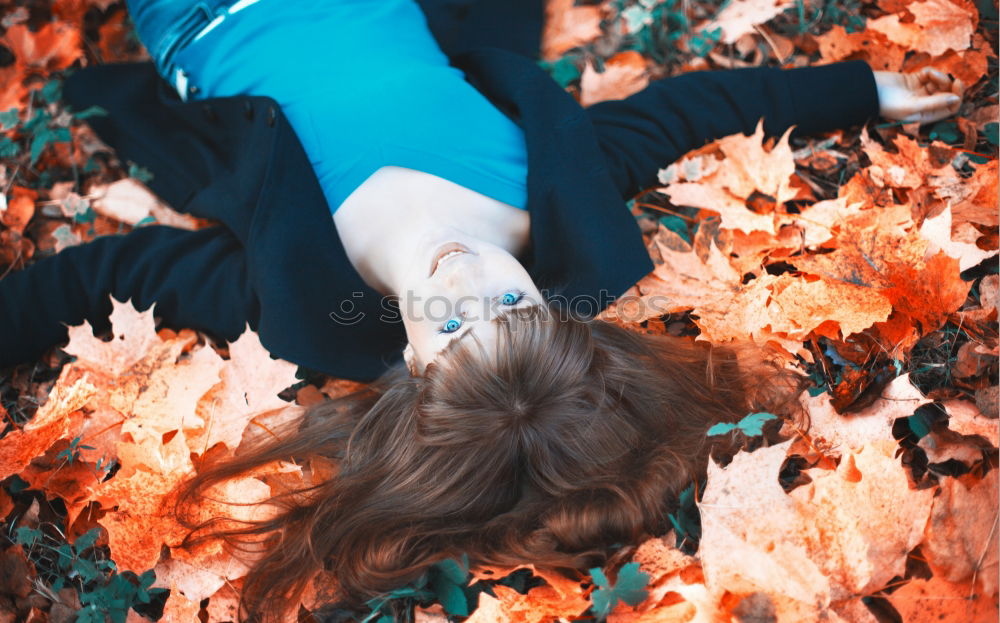 Similar – Image, Stock Photo Young woman lying down in the floor full of autumn leaves