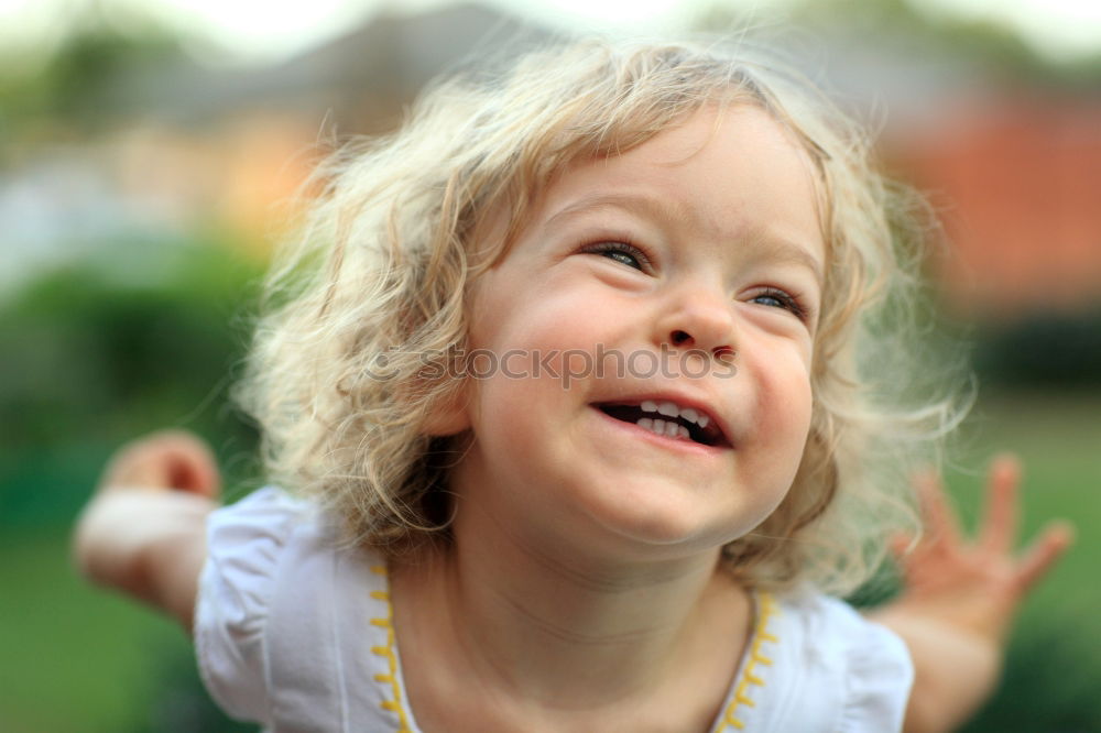 Similar – Image, Stock Photo Funny, funny, cheerful, happy, funny blonde girl outside in the garden, looks up and stretches both arms up to the tree. Little joker does nonsense, sticks out her tongue, in nature, in the park under the tree.