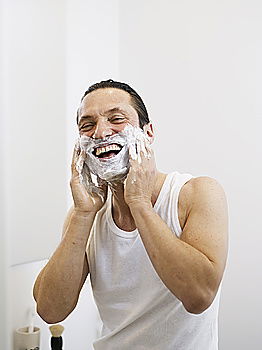 Similar – Young man applying shaving cream