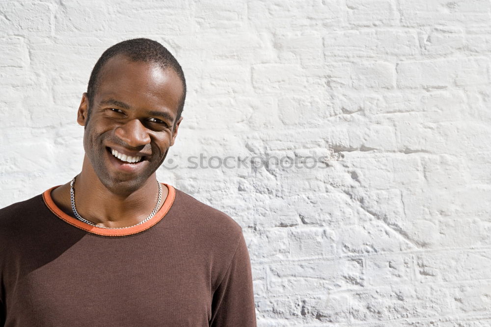 Similar – Handsome afro-american man biting his lip and looking aside in Gran via, Madrid.