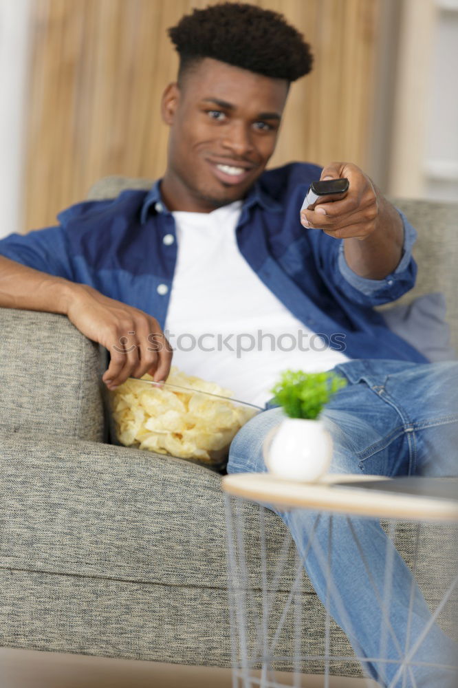 Similar – Relaxed boy holding smartphone sitting in chair at home