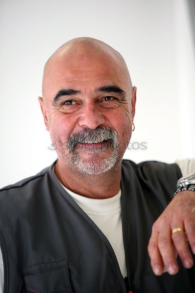 Similar – Portrait of a senior citizen with short grey hair and three-day beard in front of a blue-grey sky