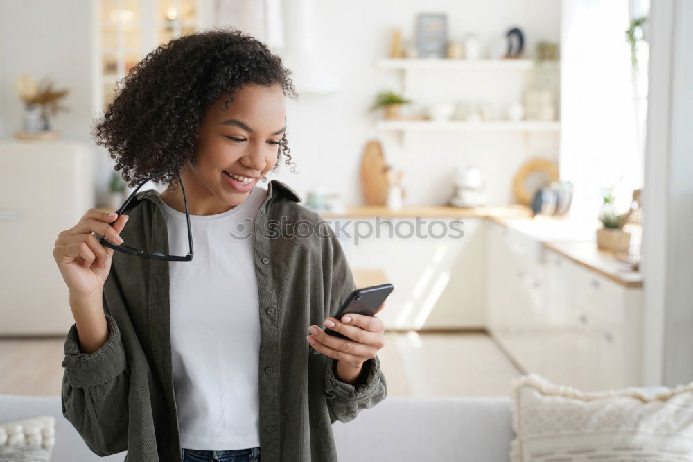 Similar – smiling young woman typing a message on cellphone