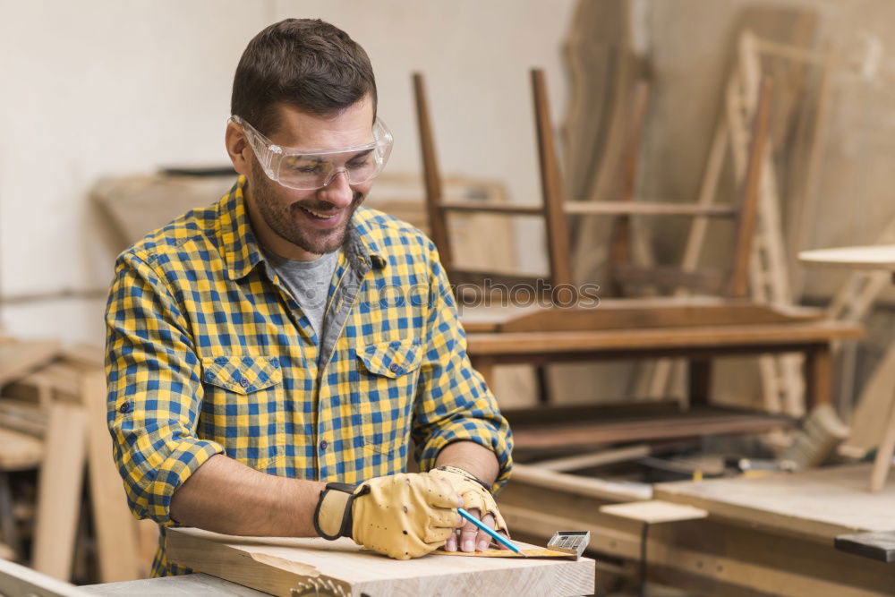 Similar – Carpenter cutting wooden board