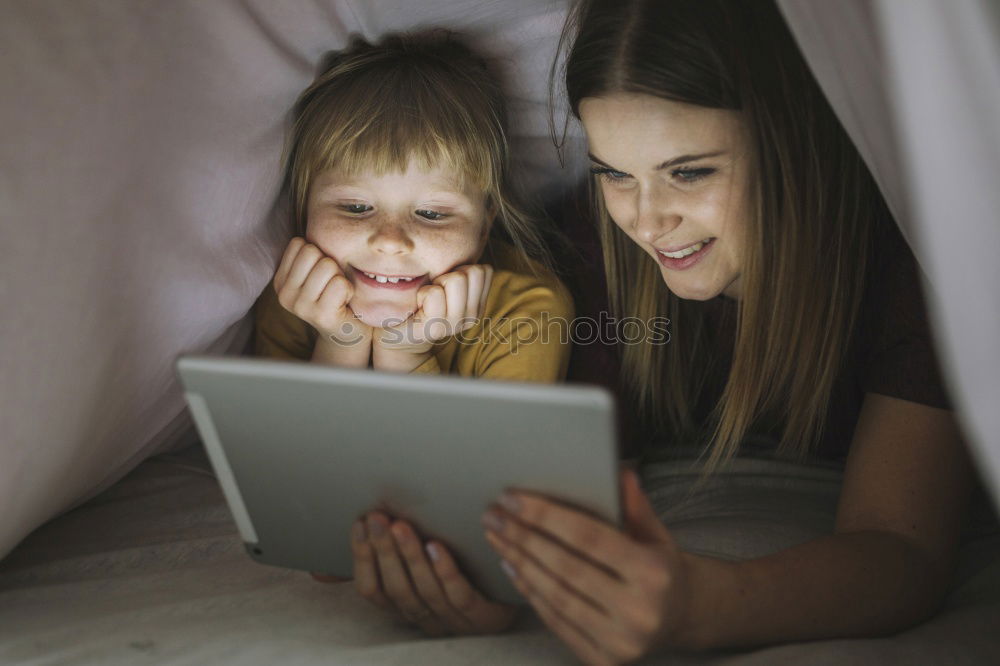 Similar – Mother and her child with digital tablet.