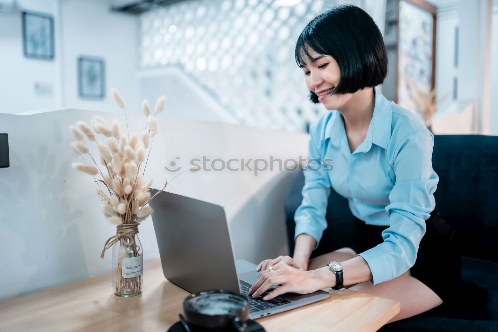 Similar – Young woman sitting at a kitchen table