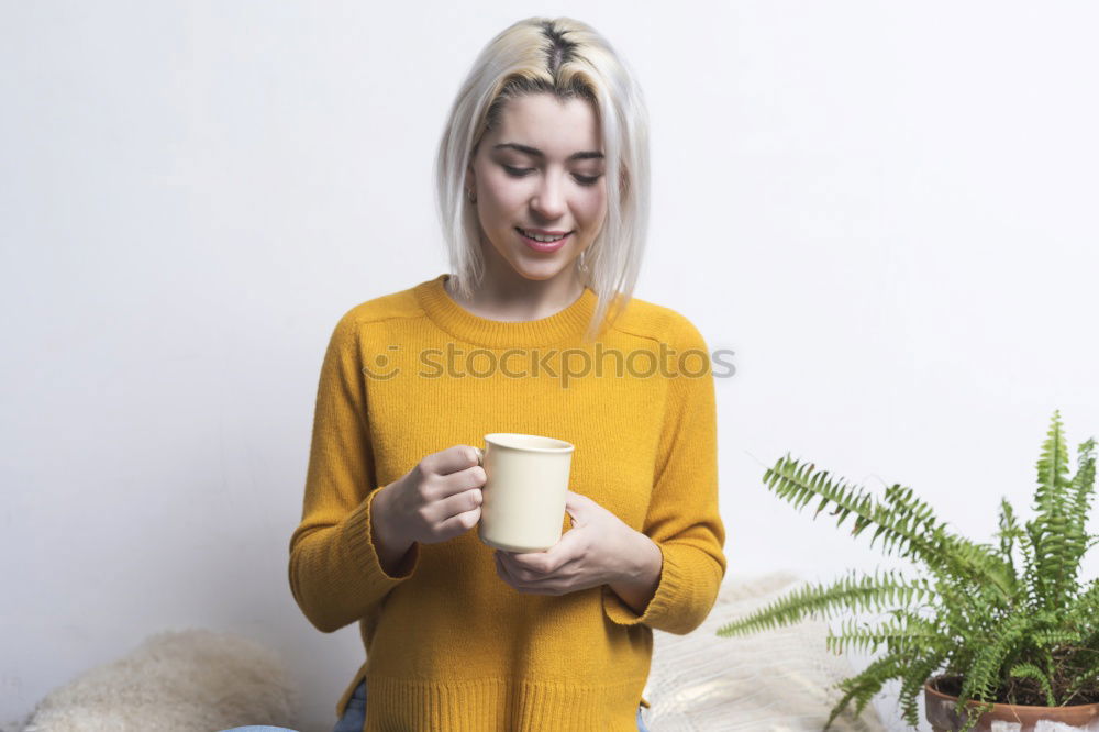 Similar – Happy young woman holding a cup of tea or coffee