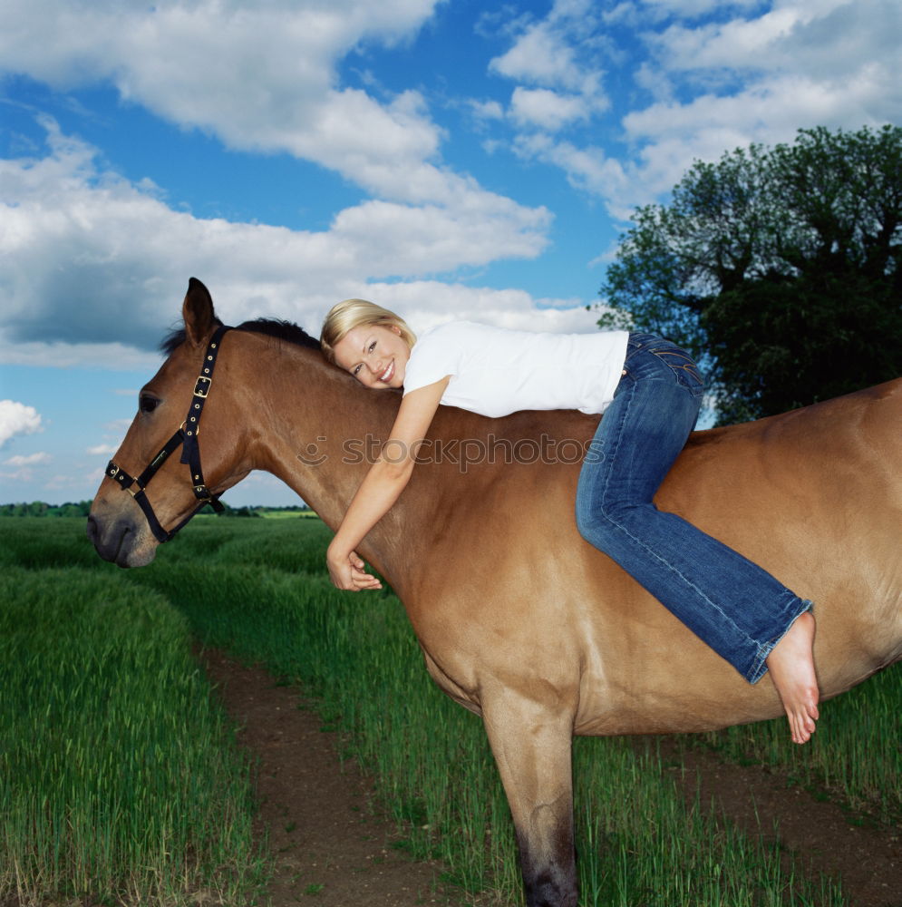 Young beautiful girl with white horse in forest. Woman horseback rider in boho style. Summertime nature scene.