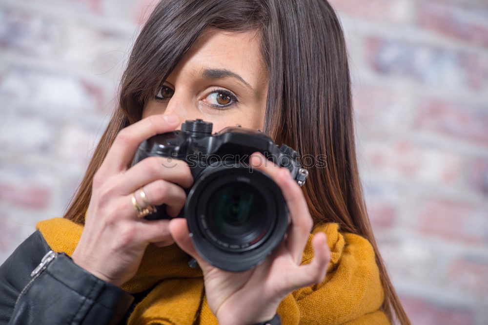 Similar – close up portrait of a young woman holding a camera. Photography concept