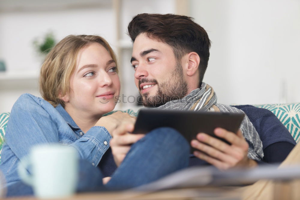 Similar – Image, Stock Photo Young couple reading book on couch at home