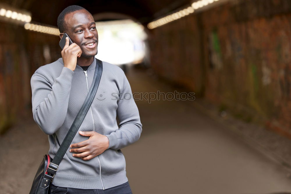 Similar – Image, Stock Photo Black young man with a smartphone in his hand